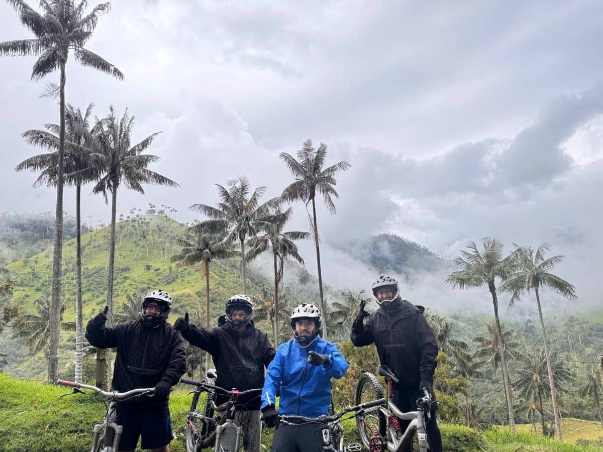 Riders and their bikes among the wax palms at La Carbonera, above Salento