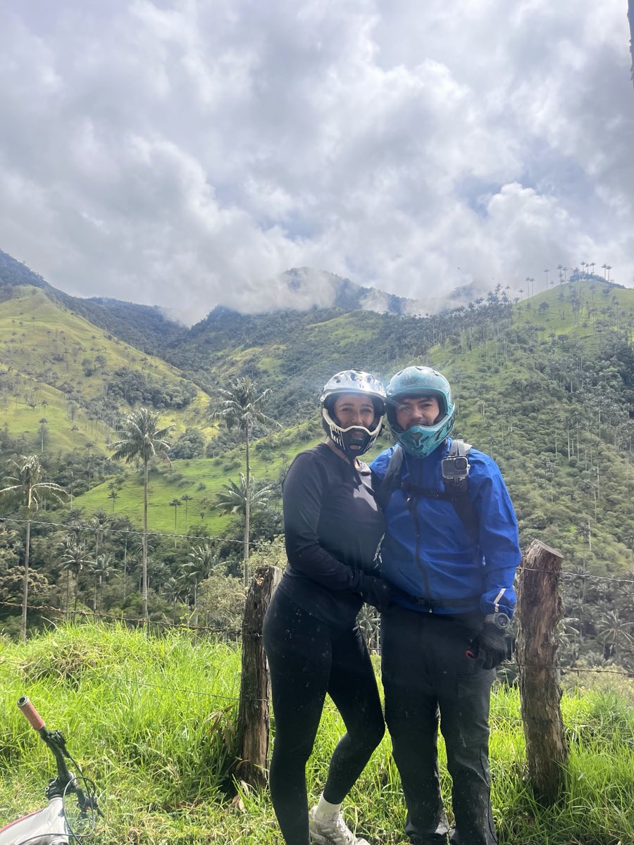 Two riders pausing at a viewpoint on the La Carbonera descent above Salento